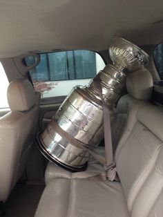 the back seat of a car is filled with silver cups