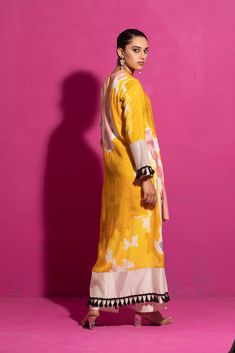 Embrace the allure of this yellow abstract print kurta set, meticulously handcrafted in cotton satin. The a-line asymmetrical kurta with full sleeves features hand-painted motifs on a cotton satin base, paired harmoniously with ivory palazzo pants in chanderi. The ensemble is highlighted with delicate hand embroidery, presenting a two-piece masterpiece of contemporary elegance. Transitional Silk Kurta With Printed Motifs, Festive Silk Kurta With Ikat Print, Designer Yellow Kurta With Printed Motifs, Designer Wear Yellow Kurta With Printed Motifs, Designer Yellow Kurta For Spring, Spring Designer Cotton Silk Kurta, Yellow Cotton Silk Kurta For Festivals, Silk Straight Kurta With Ikat Print, Silk Ikat Print Straight Kurta