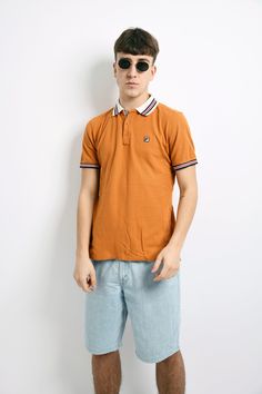 "FILA vintage polo shirt men's in orange. Size - US XS, UK/F/I S, D 48. Model is 180 cm / 5ft 11\" tall and usually wears size M. Very good vintage condition. Flat measurements: Length - 26.3\" / 67 cm; Pit to pit (chest) - 19.3\" / 49 cm. All orders are shipped every day Worldwide from EU. Safe registered standard delivery Worldwide with courier and tracking number. Free delivery from €80/$92! We are also sending with very fast Express delivery (UPS). Just choose shipping upgrade in your cart. Sporty Polo Collar T-shirt For Summer, Yellow Collared Polo Shirt For Summer, Yellow Polo Shirt With Collar For Summer, Vintage Summer Polo Collar T-shirt, Summer Yellow Polo Shirt With Polo Collar, Sporty Polo Collar Top For Summer, Yellow Summer Polo Shirt, Summer Polo Collar T-shirt For Streetwear, Sporty Yellow Polo Shirt With Short Sleeves