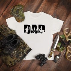 This great graphic tee is perfect for the hunting Dad. This could be a great Christmas or Father’s Day gift for your favorite dad. This is a fun shirt that can be worn on a hunting trip or just around the house. Garments come in three colors. T-Shirts come in a variety of sizes of your choice. We use high quality, soft flex vinyl which not only creates a sharp, vivid graphic but will never look "faded" or “washed out” like some inks commonly do. Processing time is 2-4 days, delivery will depend Hunting Shirts Vinyl, Deer Shirts Vinyl, Hunting Shirts For Men, Dad Shirts, Deer Shirt, Bow Hunting, Hunting Trip, Hunting Shirts, Dad To Be Shirts