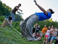 a group of people watching a skateboarder do a trick