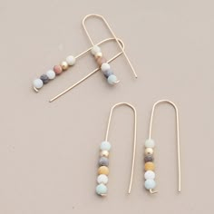 Inspired by ascension, these climbing matte finish Amazonite beads are suspended on 14k gold fill hook earrings. Earthy and elegant, the nature of these beads lends each pair its own unique color palette, reminiscent of tiny celestial bodies. 2” drop 14k gold fill ear wires Handmade Wire Jewelry, Hand Made Jewelry, Jewelry Business, Jewelry Projects, Diy Earrings