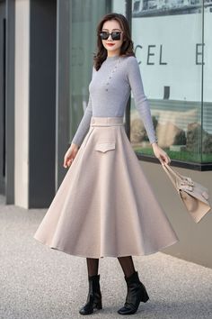 "This beige wool skirt is elegant and comfortable, which is the best choice for winter. DETAIL * More choices https://etsy.me/3Pwo3Fj * 30% wool, 30% fiber, 40% polyester * polyester lining * Two pockets * Back zipper closure * Below knee length effect * Perfect for autumn winter * Dry cleaning * Lean More about the items From the FAQs on the page bottom * The model is 170 cm (5′ 7″) tall with a 80 cm (31.5\") bust, 66 cm (26\") waist. She is wearing the plaid wool skirt in size XS. CUSTOM MADE Chic A-line Winter Skirt, Beige A-line Pleated Skirt For Fall, Elegant A-line Bottoms For Winter, Elegant Winter Maxi Skirt, Chic Cream Fall Skirt, Chic Wool Skirt For Winter, Chic Winter Wool Skirt, Elegant Solid Pleated Skirt For Winter, Chic Full Maxi Skirt For Winter