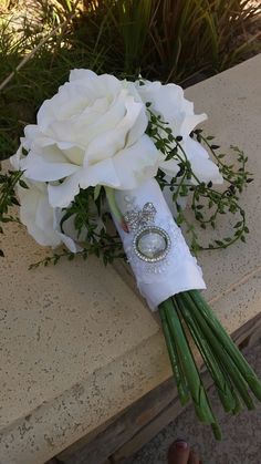 a bridal bouquet with white roses and green stems