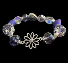 Give the gift of joy and thoughtfulness with this Purple Bracelet! Purple is known for its healing properties, aiding in mental disorders and helping individuals become one with their spirit. It promotes harmony between the mind and emotions, leading to mental balance and stability. Share the benefits of this soothing color with someone special! Spiritual Flower-shaped Bracelets For Gift, Adjustable Lavender Bracelet For Gift, Spiritual Flower Bracelets For Gifts, Spiritual Flower-shaped Bracelets As Gifts, Adjustable Lavender Spiritual Bracelets, Silver Adjustable Crystal Bracelet For Meditation, Adjustable Lavender Stretch Bracelet As Gift, Adjustable Flower-shaped Spiritual Bracelets, Adjustable Spiritual Flower Bracelet