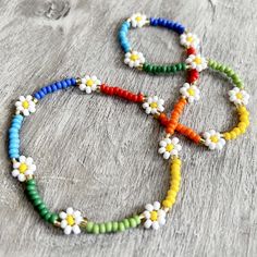 a multicolored beaded necklace with flowers on it