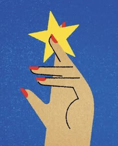 a person's hand holding a star in the air