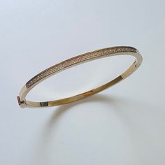 Durable and stylish, our waterproof bracelet is crafted for both functionality and fashion. Perfect for any occasion, it's the ideal accessory for those who appreciate durability and timeless elegance. Perfect for the minimalist and a beautiful piece to layer with. - 18K gold plated / stainless steel - Waterproof technology - Bangle opens and measures 56mm inner diameter. - 3mm in width. - Cubic Zirconia - Reversible Minimalist Gold-tone Bangle Bracelets, Minimalist Gold-tone Bangle Bracelet, Timeless Gold Plated Bangle Bracelet, Timeless Gold-plated Bangle Bracelet, Luxury Adjustable Bangle For Everyday, Adjustable Luxury Everyday Bangle, Adjustable Classic Gold Plated Bangle, Classic Adjustable Gold Plated Bangle, Modern Gold-tone Bracelet For Everyday Wear