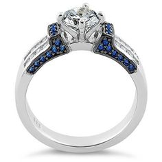 a white gold engagement ring with blue and white diamonds on the side, set in 18k white gold