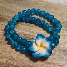 Handmade Stretch Bracelet. Hawaiian Flower With Double Beaded Bracelet Attached. Can Fit Wrists From 5 To 8 Inches Round Nicely. Save More $$$ On Bundles!!! Buy 3 Or More Items And Receive 30% Off!!! I Ship On The Same Day Unless You Make A Purchase At Night Then I Ship First Thing The The Morning. I Am A Quick Responder And If You Have Any Questions About An Item I Will Quickly Give You An Answer Or Post A Video Of The Item In Question. I Try To List All My Items At A Reasonable Price But I Als Blue Flower Bracelets For Beach, Blue Flower Beaded Bracelets For Beach, Turquoise Flower Bracelets With Colorful Beads, Turquoise Beaded Flower Bracelets, Turquoise Beaded Flower Bracelet, Blue Flower Jewelry For The Beach, Blue Flower-shaped Jewelry For The Beach, Blue Flower Shaped Beaded Bracelet For Gift, Blue Flower Beads For Gifts