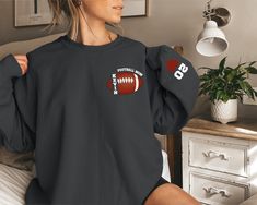 Custom Football Sweatshirt, Football Mom Sweatshirt, Sports Mom Hoodie, Custom Football Mom Sweatshirt with Kid Name,Football Season Sweater We're here to give you the best sweatshirt and hoodie options for you. We want to make everyone smile with our cute, stylish and trendy graphic sweatshirts and hoodies. We can assured you this sweatshirt or hoodie will be perfect gift whether you will buy it yourself or for someone else. PLEASE ATTENTİON We use black design for Sport grey, white and sand; w Sports Fan Hoodie With Long Sleeves, Crew Neck Hoodie For Sports Events, Long Sleeve Sweatshirt With Ribbed Cuffs For Sports, Ribbed Cuffs Long Sleeve Sweatshirt For Sports, Team-colored Fall Sports Sweatshirt, Team-colored Sweatshirt For Sports In Fall, Long Sleeve Sportswear Tops For Game Day, Sportswear Long Sleeve Tops For Game Day, Long Sleeve Letter Print Sweatshirt For Sports Events