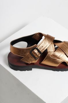 Elevate your style with our luxurious Martina Gold Sandals. The high-low design and strappy antique gold upper make it a statement piece, while the modern black buckle adds a touch of contemporary elegance. Hand crafted with a combination of rubber and leather soles, these sandals offer both comfort and style. Unsure about your size? Please refer to our sizing page or send us a message using the chat button on our website. We will answer straight away. Designer Leather Sandals With Gold Buckle, Leather Ankle Strap Sandals With Gold Buckle, Leather Sandals With Gold Buckle And Ankle Strap, Designer Open Toe Sandals With Gold Buckle, Luxury Leather Sandals With Gold Buckle, Summer Double Strap Sandals With Gold Buckle, Formal Open Toe Sandals With Gold Buckle, Formal Leather Sandals With Gold Buckle, Chic Gold Sandals With Leather Sole