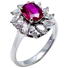 A vibrant currant red 1.00 carat Ruby and marquise Diamond engagement/cocktail ring in 14 karat white gold. The Ruby is uniquely set slightly off center in conjunction with the slant set marquise Diamonds. The 12 Diamonds have a total carat weight of 1.20 carats, graded as F-G color, VS clarity on a tapered shoulder shank. The ring is currently a size 8.00 (adjustable as needed). Offered by Charles Schwartz & Son Jewelers. Unique Engagement Rings Rose Gold, Victorian Engagement Rings, Marquise Diamond Engagement Ring, Contemporary Engagement Rings, Gold Diamond Engagement Rings, Stunning Engagement Ring, Ruby Engagement Ring, Yellow Gold Engagement, Yellow Gold Engagement Rings