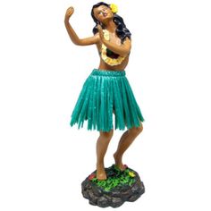 a figurine of a woman wearing a green skirt and holding a hula