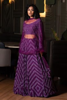 Purple can can attached lehenga skirt with sequin embellished chevron patterns. Comes with matching padded blouse and dupatta.
Components: 3
Pattern: Embroidered
Type Of Work: Cutdana,Sequin
Neckline: V-neck
Sleeve Type: Full
Fabric: Lehenga and Blouse: Georgette, Dupatta: Tulle, Lining: Shantoon, Dupion Silk
Color: Purple
Other Details: 
Attached lining
Length:
Lehenga: 44 inches
Blouse: 15 inches
Closure: Blouse: Back hook
Note: Kindly contact customer service for sleeve customization at an ex Traditional Drape Palazzo Set With Sequins For Diwali, Traditional Drape Sets With Sequins For Navratri, Sequined Traditional Style Sets For Navratri, Sequin Lehenga For Eid Reception, Eid Reception Lehenga With Sequins, Traditional Sequin Palazzo Set For Reception, Traditional Palazzo Set With Sequins For Reception, Anarkali Set With Sequins And Traditional Drape, Anarkali Sets With Sequins In Traditional Drape