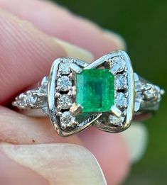 Elevate your jewelry collection with this very unique Vintage Emerald and Diamond Art Deco Style Ring--an exquisite fusion of timeless elegance and Art Deco glamour. This ring is a testament to the opulence of a bygone era, featuring a lush emerald at its center, surrounded by a dazzling array of diamonds, all set in a meticulously crafted Art Deco-inspired design.  Natural emerald weighing .44 carats Natural Diamonds weighing .15 carats.  Size: 6.5 The emerald, with its rich green hue, is a captivating focal point, symbolizing renewal and prosperity. Surrounding this vibrant gemstone are carefully arranged diamonds, adding brilliance and sophistication to the piece. The geometric patterns and intricate detailing of the Art Deco style setting enhance the ring's vintage allure, making it a Timeless Emerald Anniversary Ring, Timeless Emerald Wedding Anniversary Ring, Timeless Princess Cut Gemstone Jewelry, Exquisite Platinum Jewelry For Formal Occasions, Elegant Gia Certified Emerald Ring, Elegant Green Platinum Jewelry, Timeless Green Wedding Dress For Formal Occasion, Exquisite Emerald Cut Emerald Ring, Exquisite Emerald Cut Platinum Emerald Ring