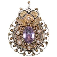 Stunning antique Victorian brooch which can also be worn as a pendant. This piece showcases a beautiful 10 mm / 7 mm prong set amethyst center. This piece has 6 natural cultured fresh water pearls each measured at 2 mm and showcases a unique hand engraved black enamel design with a filigree frame. This piece is measured at 30 mm / 22 mm and have a total weight of 6.8 grams. This piece is tested 14K gold and checked by a professional for authenticity. Heirloom Style Oval Filigree Brooch, Amethyst Brooch Jewelry For Anniversary, Heirloom Oval Filigree Brooch, Purple Brooch Jewelry Gift, Amethyst Brooch For Anniversary, Heirloom Filigree Oval Brooch, Purple Amethyst Brooch As A Gift, Amethyst Brooch Jewelry Gift, Victorian Pendant Brooches With Cabochon