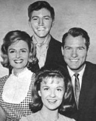 an old black and white photo of four people