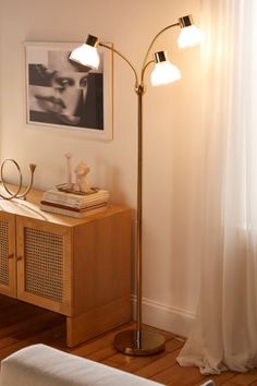 a floor lamp in the corner of a living room