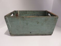 an old wooden box sitting on top of a white table