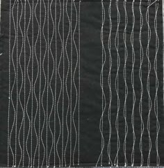 a piece of black fabric with white lines on it