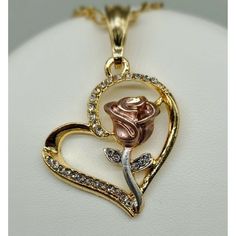 Heart With Rose Necklaceheart Pendant With Two Tone Rose Pendant Heart Has Shinny White Rhinestones Around Pendant And Necklace 24k Gold Filled Pendant Measures 1 1/2" Necklace Measures 22" Cadena De Corazon Con Rosamedalla De Corazon Con Rosa La Roza Es De Dos Tonos El Corazon Tiene Piedras Blancas Alrededor Es De 24k Oro Laminado Medalla Mide 1 1/2" Cadena Mide 22" Rose-colored Jewelry For Valentine's Day Anniversary, Valentine's Day Rose Design Jewelry For Anniversary, Heart Pendant Necklace With Rose Design For Anniversary, Rose Necklaces For Valentine's Day, Anniversary Heart Pendant Necklace With Rose Design, Elegant Rose Heart Necklace, Elegant Rose Heart Shaped Necklace, Valentine's Day Gift Jewelry With Rose Design, Heart Pendant Jewelry With Rose Design For Anniversary