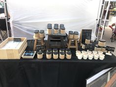 a table topped with lots of jars and cups