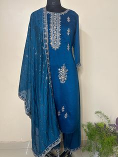 Silk Blend Navy Blue Embroidered Straight Kurta With Trousers and Dupatta Indian Wedding Wear Salwar Kameez / Indian Wedding Dress / Plus Size Cotton Kurta Dress Traditional Indian Wear / Salwar Kameez Dupatta / Kurti Palazzo Set The set contains: 1 Straight Kurta 1 Trousers 1 Dupatta Kurta: The navy blue straight Kurta has a round neck design with sequinned work details in front. The Kurta measures till calf length and has straight hemline. Sleeve length :  3/4 Sleeves Sharara :  Solid trousers Traditional Blue Palazzo Set For Festive Occasions, Traditional Blue Palazzo Set For Festive Season, Traditional Drape Blue Embroidered Palazzo Set, Blue Art Silk Palazzo Set For Eid, Blue Dola Silk Palazzo Set With Straight Kurta, Embroidered Silk Blue Palazzo Set, Embroidered Blue Palazzo Set For Transitional Season, Blue Palazzo Set With Resham Embroidery For Festive Occasions, Festive Blue Palazzo Set With Resham Embroidery