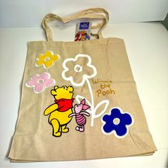 Nwt. Disney Primark Tote Bag. Cute Winnie The Pooh Canvas Tote Bag Approx. 16”H X 14”L. Says Winnie The Pooh With Pooh Bear, Piglet And Some Colorful Flowers. Other Side Of Bag Is Plain. Canvas Double Straps. Perfect For Winnie The Pooh Fans! Disney Yellow Bags For Everyday Use, Disney Yellow School Bag, Yellow Disney School Bag, Winnie The Pooh Canvas, Disney Primark, Painting Tote Bags, Primark Bags, Disney Tote Bags, Disney Tote