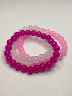 3Pc Pink beaded bracelet set. Includes hot pink, light pink and cloudy white. These bracelets have a shiny glossy look, have a cooling feel and are light weight. The color of the product may look slightly different due to lighting. Pink Hypoallergenic Beaded Bracelets, Pink Stretch Bracelet With Colorful Beads, Pink Beaded Stretch Bracelet, Pink Hand-strung Round Crystal Bracelet, Pink Stackable Stretch Bracelet With Round Beads, Pink Hand-strung Crystal Bracelet, Hypoallergenic Pink Beaded Bracelets For Friendship, Pink Stackable Beaded Bracelets, Adjustable Pink Beaded Bracelets With 8mm Beads