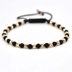 ✨Unveil the epitome of sophistication with our meticulously handcrafted bracelet, designed for the modern man. Featuring premium 4mm matte black onyx beads, complemented by twenty-one 4mm and two 2.5mm 14K gold beads, this accessory is a true testament to luxury and refined taste. Gold Bracelet Key Features: ✅Superior Craftsmanship: Each bracelet is handcrafted with precision, ensuring a piece that's as unique as you are. ✅Premium Materials: Made with 4mm matte black onyx beads and 23 genuine 14 Elegant Black Braided Bracelet For Formal Occasions, Modern Onyx Bracelets As Gift, Black Round Gold Bracelet As Gift, Black Gold Round Bracelet As Gift, Elegant Hand-strung Bracelets, Luxury Adjustable Black Jewelry, Luxury Black Beaded Bracelet As Gift, Elegant Black Wristband Gift, Luxury Black Beaded Bracelets As Gift