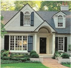 a white house with black shutters and windows