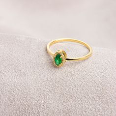 Emerald, which is considered to be the stone of love, sensitivity and loyalty, is seen as a symbol of harmony in relationships. Our oval emerald and diamond ring is both stylish and suitable for daily use. Bring a smile to your loved ones' faces by gifting them on their birthday, graduation day, wedding anniversaries and many more special occasions.   Emerald is the birthstone of May. Our necklace compatible with our ring: https://queenjewelryturkey.etsy.com/listing/1391092889/oval-cut-real-diam Elegant Emerald Cubic Zirconia Ring With Halo, Elegant Emerald Ring With Halo In Cubic Zirconia, Elegant Emerald Halo Ring With Cubic Zirconia, Elegant Halo Birthstone Ring With Cubic Zirconia, Gift Emerald Ring With Cubic Zirconia Halo, Dainty Diamond Ring For May Birthstone Formal Occasion, Dainty Diamond Ring For May Birthstone Formal, Elegant Solitaire Diamond Ring For May Birthstone, Formal 14k Gold Emerald Ring With Halo