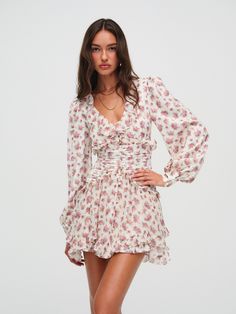 Embrace your inner flower child with the Jayleen pink mini dress, designed to take you through the early days of spring and into late summer. This ruffle mini dress features an ultra-feminine pansy burnout print, cascading ruffle details, and a handkerchief hem skirt. Ruffled Mini Hem Dress For Brunch, Pink Floral Print Mini Dress, Feminine Floral Print Ruffle Dress, Mini Dresses With Ruffles, Knee-length Ruffle Dress For Spring Garden Party, Pink Mini Ruffle Dress For Garden Party, White Floral Print Ruffle Dress For Spring, Chic Floral Mini Dress For Spring, Pink Mini-length Ruffle Dress For Garden Party