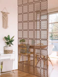 the room divider is made out of wood and has an intricate pattern on it