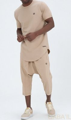 QL Relaxed Fit Nautik Set in Beige Description:Enjoy the warmth of summer with a fresh new look! This T-shirt and shorts set offers comfort, functionality and style. Featuring a shirt with a round neck and a stylish round hem and a three-quarter shorts that lets you enjoy the sun while keeping covered. QL Relaxed Fit Nautik Set is all you need to feel at your best this season. Modern Islamic clothing for men Very high-quality fabric from top brands 2 pieces QL Relaxed Fit Nautik Set Short sleeve Modern Islamic Clothing, Relaxed Trousers, Vans T Shirt, Modest Wear, Islamic Clothing, Holiday Wardrobe, Enjoying The Sun, Hippie Outfits, Bohemian Dress