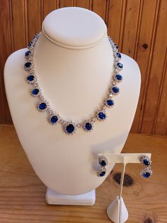 Created sapphire and diamond/zircon necklace and earring set.  5mm to 6mm sapphires and 1mm to 3mm diamond accents on necklace.  Chain is 18 inches non adjustable.  Earrings are 1.5 inches with a 1 inch drop.  4mm to 5mm sapphires and 1mm to 3mm diamond accents.  Set in stamped 925 silver. Zircon Necklace, Sapphire Bracelet, Necklace And Earring Set, Jewelry Design Necklace, Sapphire Jewelry, Wedding Jewellery, Wedding Jewelry Sets, Floral Earrings, Jewellery Sets