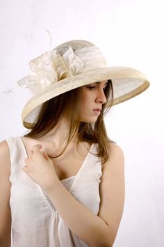 Gorgeous and chic extra wide brim sinamey hat with a astonishing decoration from ivory satin with golden dots, sinamey ribbon with golden stripes and white feathers. The wide brim make it really special and it suits almost all face types. The hat is hand blocked on a wooden block and hand stitched to perfection in Irina Sardareva millinery atelier. It is great to wear on Derby races, Cocktail parties, Weddings, Tea parties, etc.This hat is on stock  size 57 cm / 22.25''.Other sizes and colors ar Elegant Fitted Panama Hat With Curved Brim, Elegant Cream Panama Hat With Flat Brim, Elegant Brimmed Panama Hat, Elegant Short Brim Panama Hat For Kentucky Derby, Elegant Curved Brim Panama Hat For Kentucky Derby, Elegant Adjustable Flat Brim Panama Hat, Elegant Panama Hat With Short Brim For Kentucky Derby, Elegant Panama Hat With Curved Brim For Kentucky Derby, Fitted Elegant Panama Hat For Formal Occasions