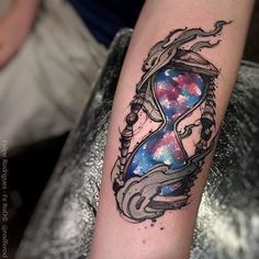 a tattoo with an hourglass in the center and stars on it's arm