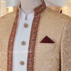 Elevate your formal wear with this stunning golden sherwani, perfect for weddings and festive occasions. Key Features: Color: Luxurious golden hue that radiates elegance and sophistication. Embroidery: Intricate floral patterns enhance texture and visual appeal, creating a regal look. Embellishment Work: Rich dark embellishments along the neckline and borders add depth and contrast, enhancing the overall design. Open Front Shape: Stylish open front design for ease of wear and a modern touch. Inn Gold Lehenga With Dabka On Jamawar, Gold Unstitched Suit With Intricate Embroidery For Wedding, Ceremonial Elegant Bandhgala With Dupatta, Festive Gold Unstitched Suit With Intricate Embroidery, Elegant Ceremonial Bandhgala With Dupatta, Gold Unstitched Wedding Suit With Intricate Embroidery, Gold Jamawar Set With Intricate Embroidery, Elegant Nehru Jacket With Dupatta For Ceremonial Occasions, Gold Unstitched Suit With Intricate Embroidery For Festive Occasion