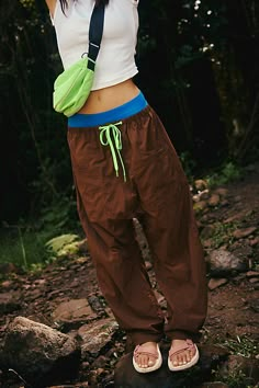 Hike on in these durable, water-resistant pants, featuring a slightly barrel-legged silhouette and easy-access doubled front pockets. **Fit:** Relaxed fit; barrel leg; high-rise **Features:** 100% Nylon fabrication; water-resistant; durable; drawstring adjustable waistband; snap closure fly; doubled front pockets; drop in back pockets; hits just above ankle **Why We | Well Played Pants by FP Movement at Free People, Argon Oil, XS Bouldering Pants Women, Vuori Outfit Women, Baggy Cotton Pants, Rock Climbing Pants, Traveling Clothes, Camping Pants, Camping Fashion, Hiking Trousers, Argon Oil