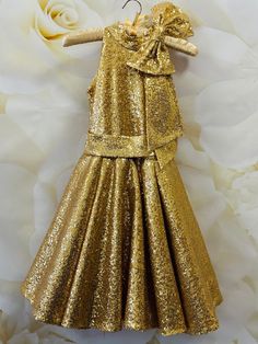 Amazing unique sequins cocktail dress in gold color. Dress is made  from high quality sequins fabric and decorated with  bow.           Zipper back. Can be made in any size and color. Gold Sleeveless Sequin Fabric For Party Season, Gold Sequin Fabric For Party Season, Elegant Sequined Pageant Dress For Party, Gold Sequin Glitter Dress For Evening, Gold Embellished Sequin Dress For Party Season, Gold Glitter Dress For Wedding, Gold Glitter Sequin Evening Dress, Holiday Sequined Pageant Dresses, Holiday Sequin Pageant Dress