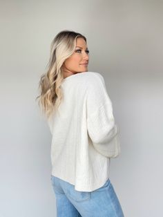 This Delightful Knit Sweater is the perfect addition to your wardrobe. Featuring a v neckline and ribbed detailing, this garment is luxuriously crafted with textured ultra-stretchy softness. Noticeably bright, cozy and relaxed fit, with bell sleeves, this sweater is perfect for an elevated casual brunch date, shopping, dinner, or work wear. Classy and sophisticated, it is a timelessly versatile piece. 50% Acrylic 30% Nylon 20% Cotton Hand wash cold. Winter White V-neck Tops For Spring, Chic White Sweater With Ribbed Neckline, Off White V-neck Top For Fall, Cream Knit Top, Cream V-neck Top For Winter, Spring V-neck Tops In Winter White, Cream Knit Tops With Soft Texture, White Ribbed Knit Top For Fall, V-neck Ribbed Sweater For Layering