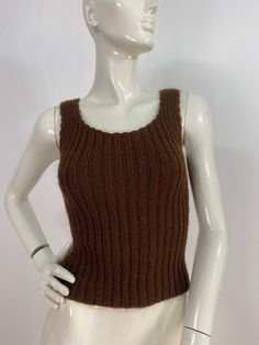 "Brown knit tank, knit tank top, fits like a women's size small, please verify exact measurements below Measurements:  Shoulder (outer seam-seam)11\"/bust(pit-pit)13\"(stretches several inches)bottom width 12\"-20\"/length 19\" Mannequin measurements:  5'8\", bust 34\", waist 25\", hip 33\" Please note that vintage clothing sizes can vary greatly.  The Measurements provided  are approximate and are taken lying flat.  I suggest taking a similar garment from your wardrobe and measure it while lying flat.  This way you can compare measurements.   Don't forget to enlarge the photos and take a closer look at this genuine vintage item!! I will ship your item off within 1-2 business days. I ship expedited for all Canadian and US orders. All other destinations world wide will be shipped surface an Fitted Ribbed Sleeveless Knit Top, Fitted Sleeveless Sweater Vest Casual, Casual Fitted Sleeveless Sweater Vest, Casual Fitted Cami Vest, Ribbed Knit Tank Sweater Vest, Fitted Sleeveless Knit Sweater Vest, Fitted Brown Sleeveless Tank Top, Brown Winter Vest Top, Ribbed Knit Fitted Tank Top