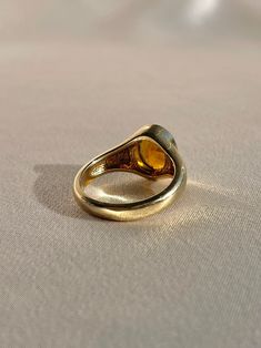 10k yellow gold signet ring by 23carat featuring a beautiful faceted citrine in a bezel setting. Excellent condition Size: 6.75 resizable* Weight: 5.7 grams Band: 11.0 mm (front), 3.0 mm (back) Citrine: 9.0 mm x 8.0 mm oval cut Hallmarks: 10k, water barrel and heart for 23carat Handmade to order, please allow for approximately 1 to 3 weeks before shipping For more details or customization options, emails us at info@shop23carat.com Water Barrel, Gold Signet Ring, Signet Ring, Bezel Setting, Oval Cut, 3 Weeks, Citrine, Barrel, Gemstone Rings