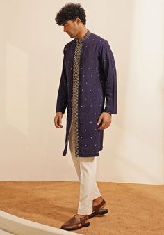 Featuring an elegant Navy Blue Kurta Set, this ensemble includes a button-down kurta designed with a Chinese collar and a hidden placket. The hand-embroidered details on the Kurta add a touch of grace and sophistication. Teamed with elegant white pants, this kurta set combines traditional elegance with contemporary style. Perfect for special occasions like Mehendi or Sangeet. Composition : Chanderi Silk Care: Dry Clean Only and Vacuum Storage This product can be customized for sleeves, length and colour Delivery : 4-6 weeks as the product is hand crafted. Check Size Guide or choose MySize for free customisation (All Sizes above XL can be made at 15% additional cost) For more information and sizes please contact fabiliciousfashion@gmail.com or visit our Copenhagen studio. About the Designer