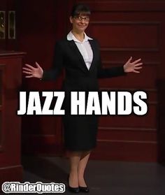 a woman standing in front of a podium with her hands out and the words jazz hands written on it