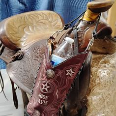 a cowboy's saddle with an empty bottle in it