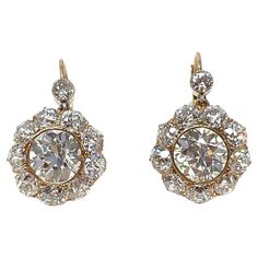 An impressive pair of antique diamond cluster earrings set in 14K gold. The old mine cut and old European cut diamonds total approximately 10 carats total weight. These are show stopper earrings which have a secure lever back fastener, allowing the earring to move and catch the light and the eye of the beholder. Circa 1880-1900 Luxury Classic Cluster Earrings With Diamond Accents, Luxury Yellow Gold Sterling Silver Cluster Earrings, Luxury Yellow Gold Cluster Earrings With Vvs Clarity, Antique Diamond Earrings, Victorian Drop Earrings, Art Nouveau Pendant, Diamond Cluster Earrings, European Cut Diamonds, Antique Diamond