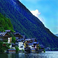 houses on the shore of a lake surrounded by mountains